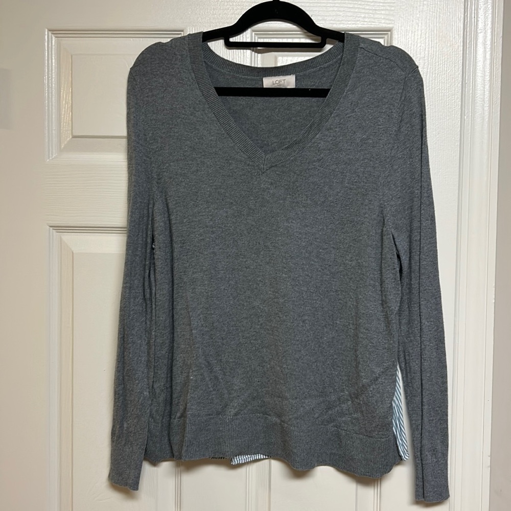 Gray loft sweater with blue and white stripes on the back